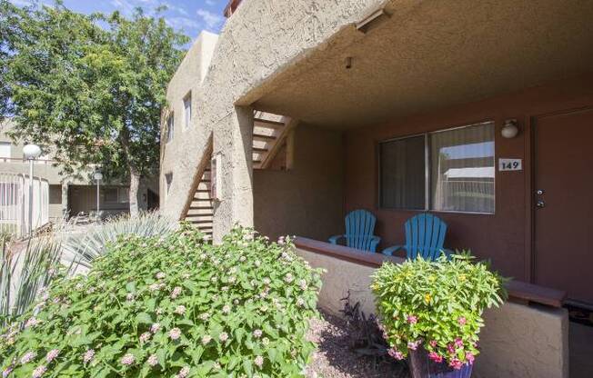 A house numbered 149 has a blue chair on the porch.