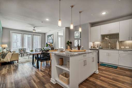 A modern kitchen with a dining table and chairs.