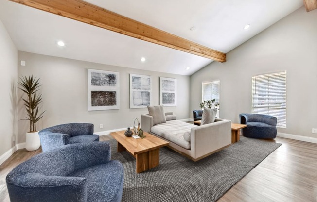 a living room with couches and chairs and a rug