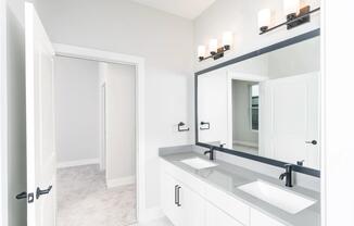 Designer bathrooms featuring quartz countertops and dual sinks for ultimate comfort and style.