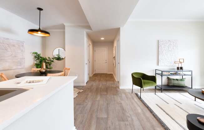 a living area with white walls and hardwood floors