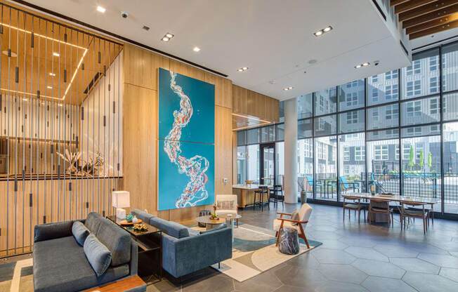 the lobby of an office building with a blue mural on the wall and a couch