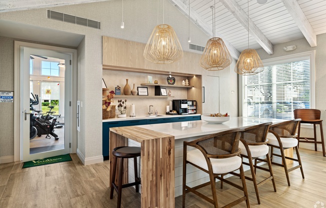 A kitchen with a bar area and a dining table.