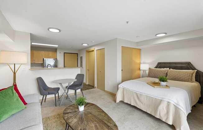 Studio Apartment with Cozy Living Area, Bedroom with Recessed Lighting, and View of Kitchen and Dining Area at Villaggio Apartment Homes, WA 98402