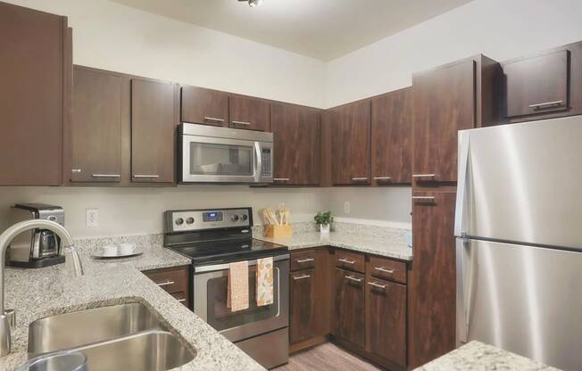 a kitchen with stainless steel appliances and granite counter tops