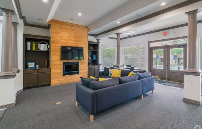 the retreat apartments l living room with fireplace and blue couch