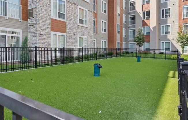 a yard with a fire hydrant in front of an apartment building