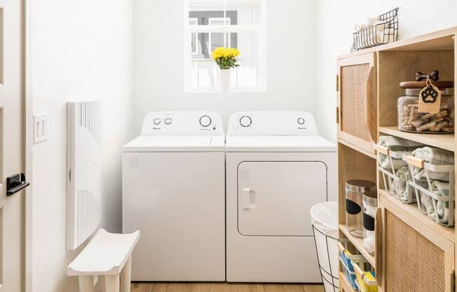 a small laundry room with a washing machine and a washer and dryer