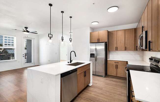 A modern kitchen with wooden cabinets and a white island.