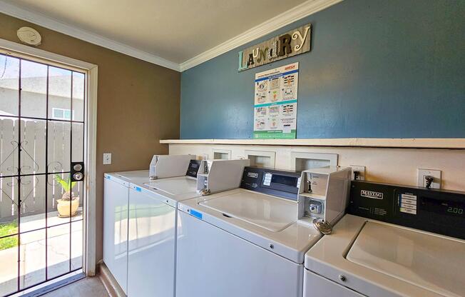 a building with a clock on the side of a snow covered road