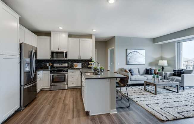 Spacious kitchen with quartz counter tops and spacious living area of 2 bedroom apartment for rent at Ascend at Woodbury best new apartments Woodbury MN 55129
