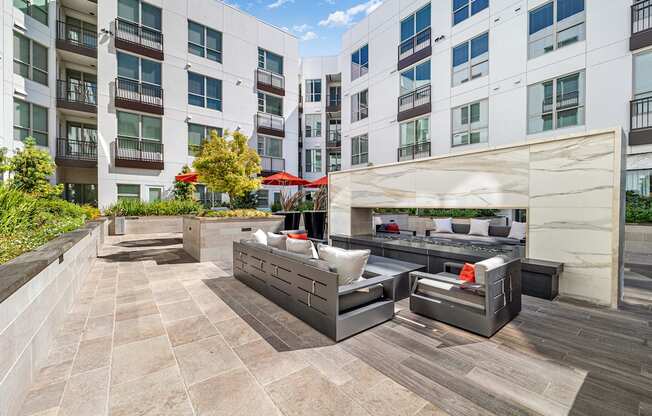 Contemporary outdoor lounge with sleek seating gathered around a double-sided fireplace for cozy evenings