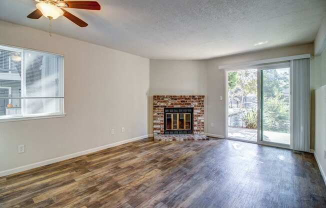 A room with a fireplace and sliding glass doors.