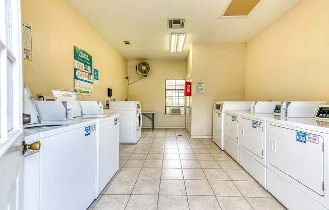 A laundromat with rows of washers and dryers.