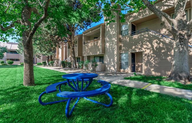 blue picnic table in front of community building