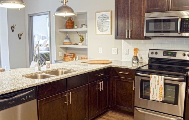 a kitchen with stainless steel appliances and granite counter tops