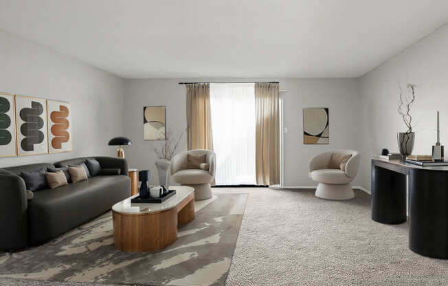 A modern living room with a grey sofa, a wooden coffee table, and a large window with curtains.