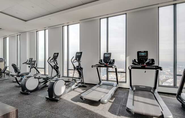 an image of a gym with treadmills and exercise bikes