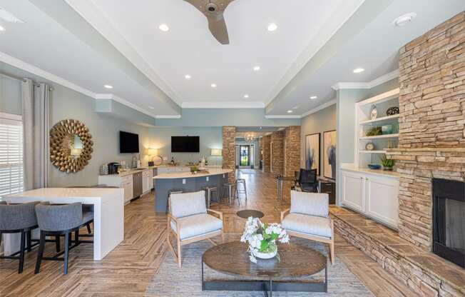 a living room with a fireplace and a table with chairs