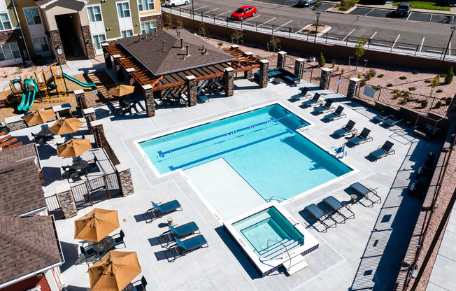 an overhead view of a swimming pool with chairs and umbrellas