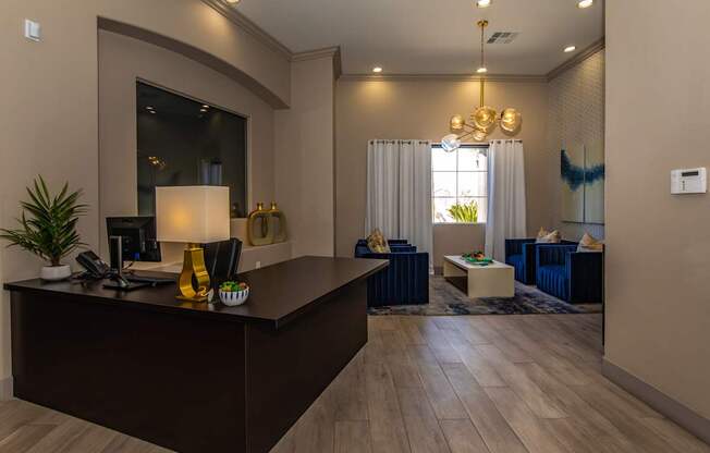 A modern office with a dark wood desk and a large mirror on the wall.