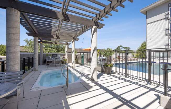 another view of the pool and hot tub at the whispering winds apartments in pearland, tx