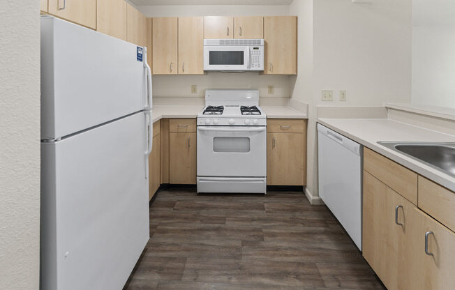 Two Bedroom Kitchen with Microwave and Gas Range at Hunters Pond Apartment Homes, Champaign, IL