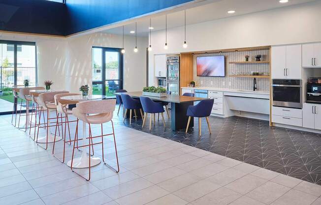 a kitchen with a bar and chairs and a table