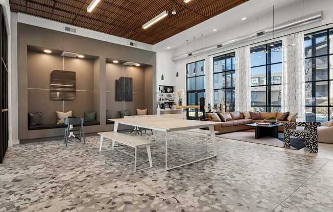 A modern living room with a wooden ceiling and a large window. at Bridge at Tech Crossing, Austin, TX