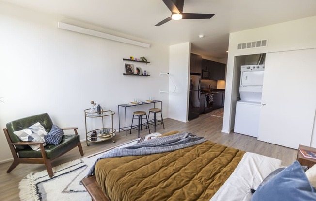 a bedroom and living room with a bed and a kitchen at Analog PDX Apartments, Oregon