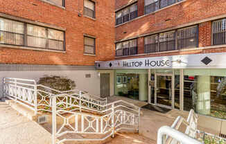 The entrance to the Hilton House building with a white railing in front.
