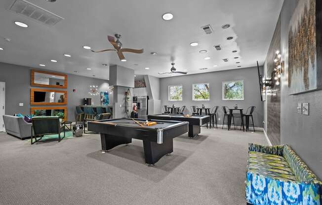 A room with a pool table and a couch.
