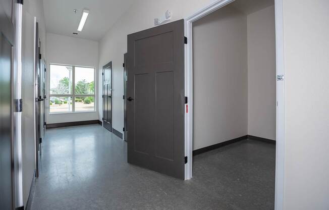 A room with a grey floor and a grey door.