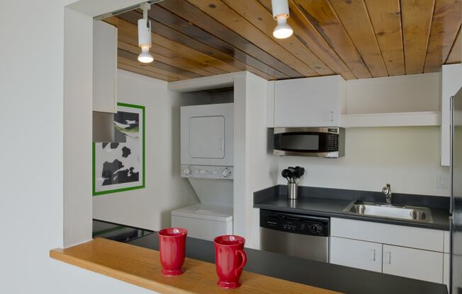 a kitchen with white cabinets and a sink and a microwave at Tindeco Wharf, Baltimore, 21224