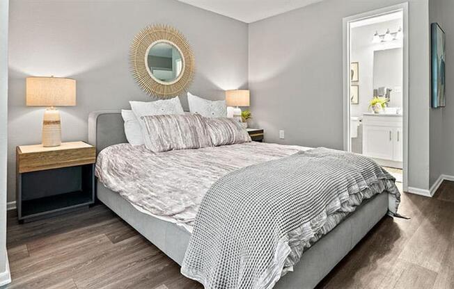 a bedroom with a bed and a mirror at Trails at Short Pump Apartments, Richmond