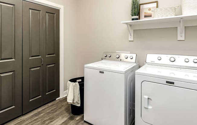A white washing machine and dryer in a laundry room.