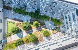an aerial view of an apartment building with a green courtyard