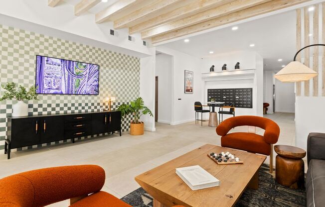 A living room with a checkered wall and a television.