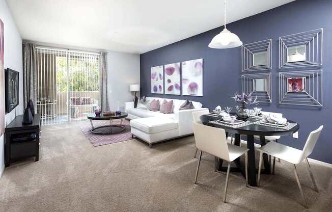 A modern living room with a dining table and chairs. at La Jolla Crossroads Apartments, California
