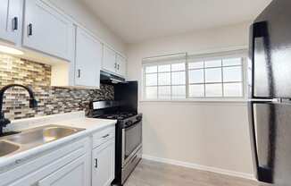 a kitchen with stainless steel appliances and white cabinets