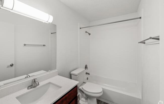 a bathroom with a sink toilet and a bath tub