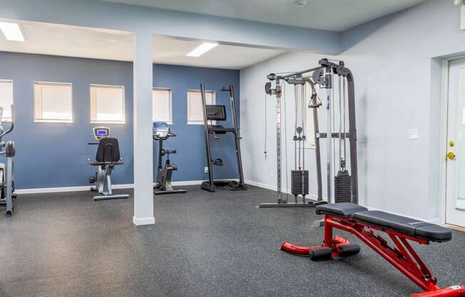 a gym with exercise equipment and weights at the flats