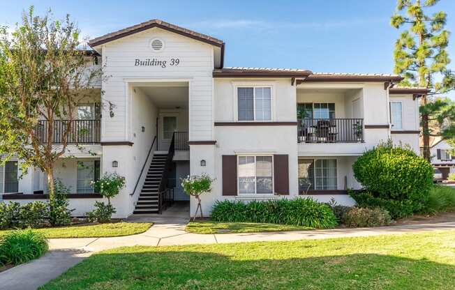 Rancho Cucamonga, CA Apartments - Exterior View of Barrington Place Apartments Building Surrounded By Lush Landscaping