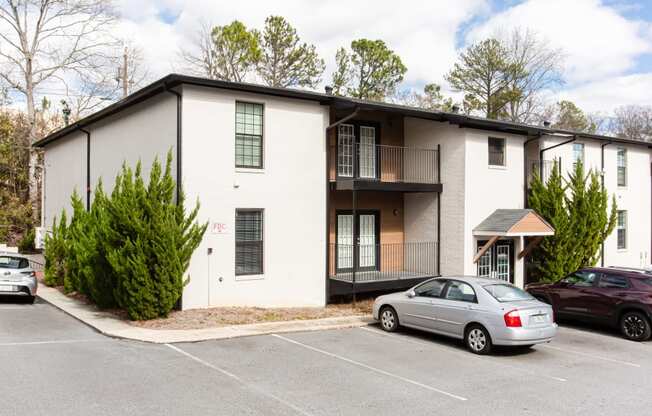 Exterior photo of parking lot and apartments at Parkside Sandy Springs Atlanta, GA