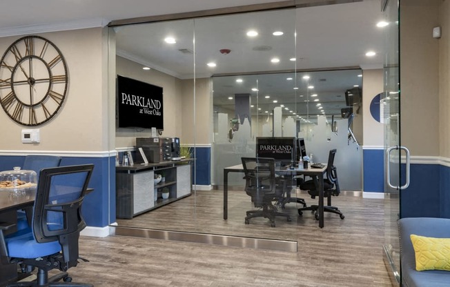 a conference room with a clock on the wall and a table with chairs