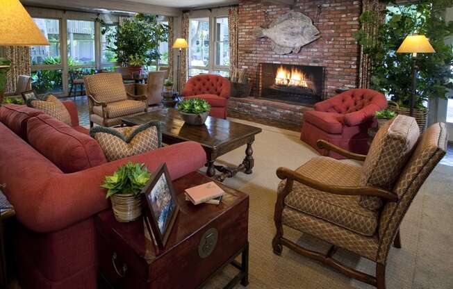 a clubhouse living room filled with furniture and a fireplace