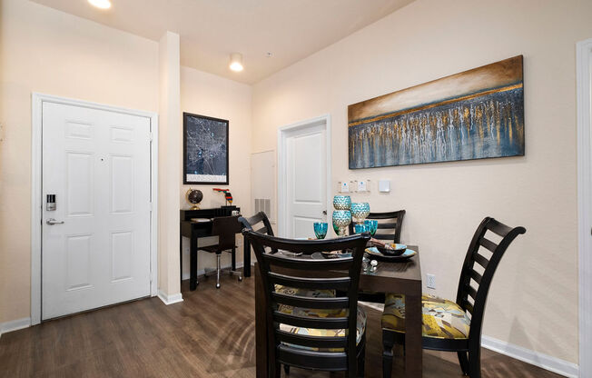 a dining room with a table and chairs