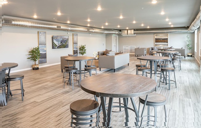 a communal area with tables and chairs in a large room at Technology Park Apartments, Rochester