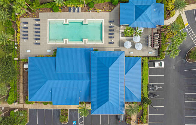 a birds eye view of a swimming pool with a blue roof