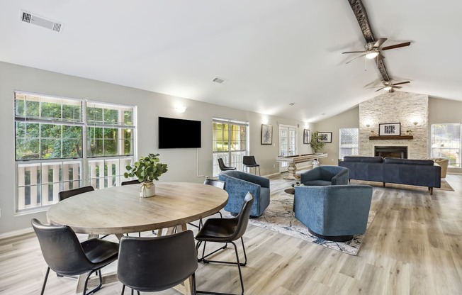 a living room with a table and chairs and a fireplace